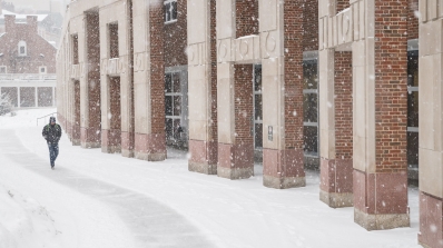 Student walking in winter by Berry Library
