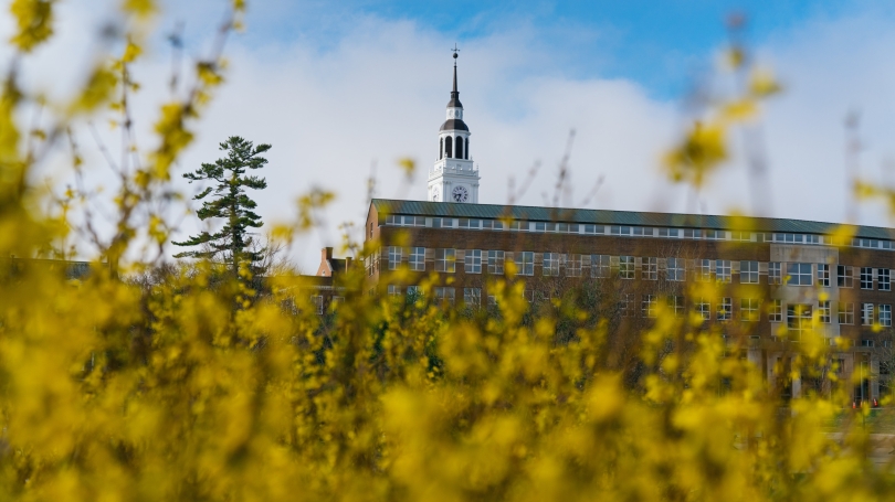 Baker Tower behind Carson Hall and budding forsythia