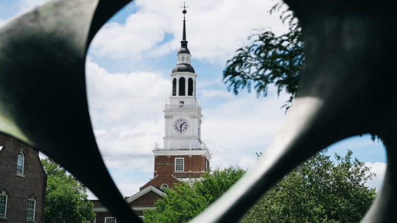 Photo of Baker clock tower through a sculpture on Dartmouth campus