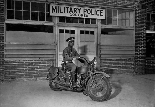 A member of the military police on motorcycle stands ready to answer all calls around his area. Columbus, Georgia, 1942 (National Archives)